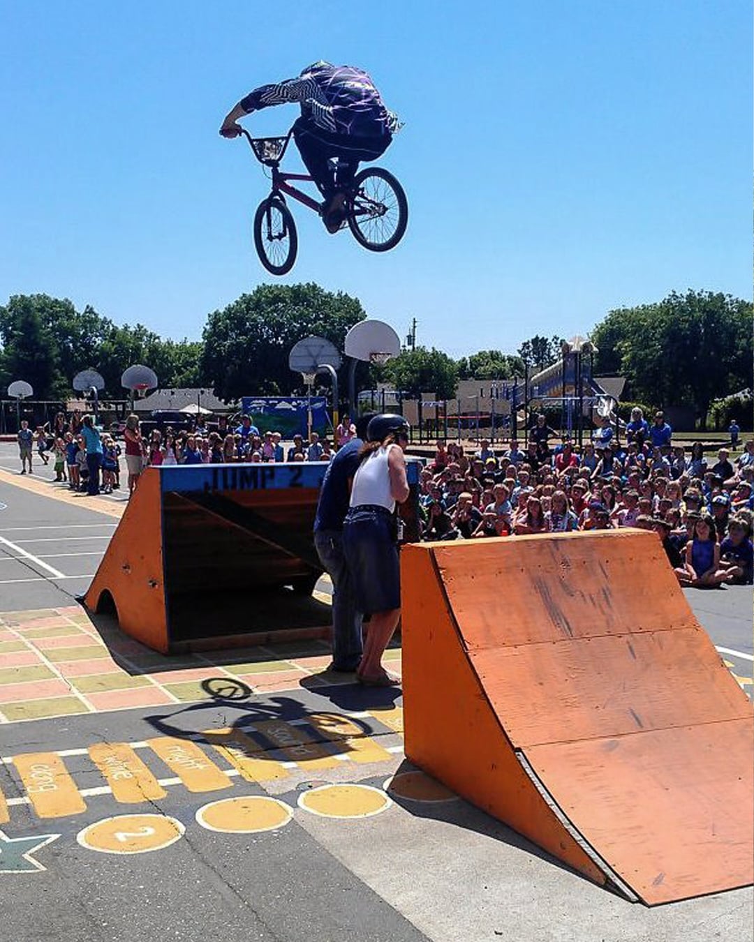 Dan's employee Mike L gapping over some teachers at a school show.