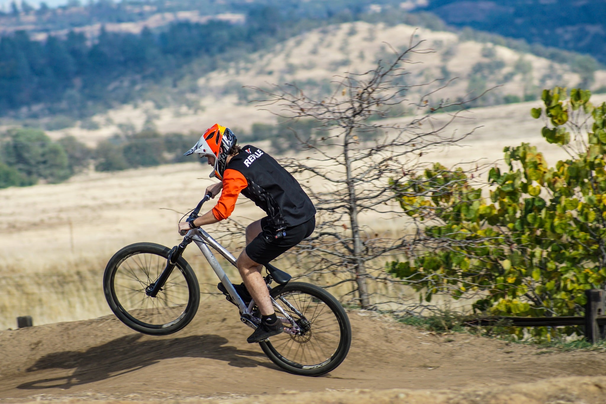 Dirt Jump MTB rider manualling a roller.