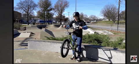 Gif of a BMX rider tossing a barspin properly