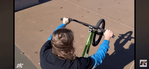 Gif of a BMX rider tossing the bars clockwise