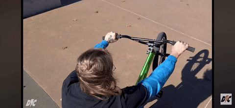 Gif of a BMX rider tossing the bars clockwise.