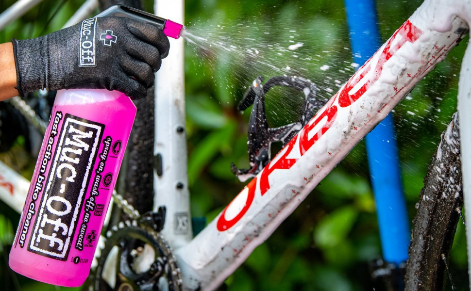 Person cleaning Gravel Bike with Muc-Off cleaning solution