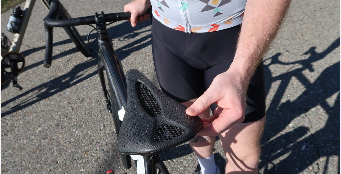 cyclist touching 3d-printed saddle