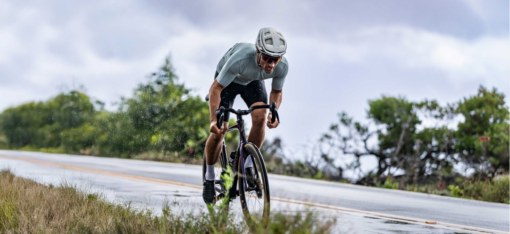 Road bike cyclist riding on wet road