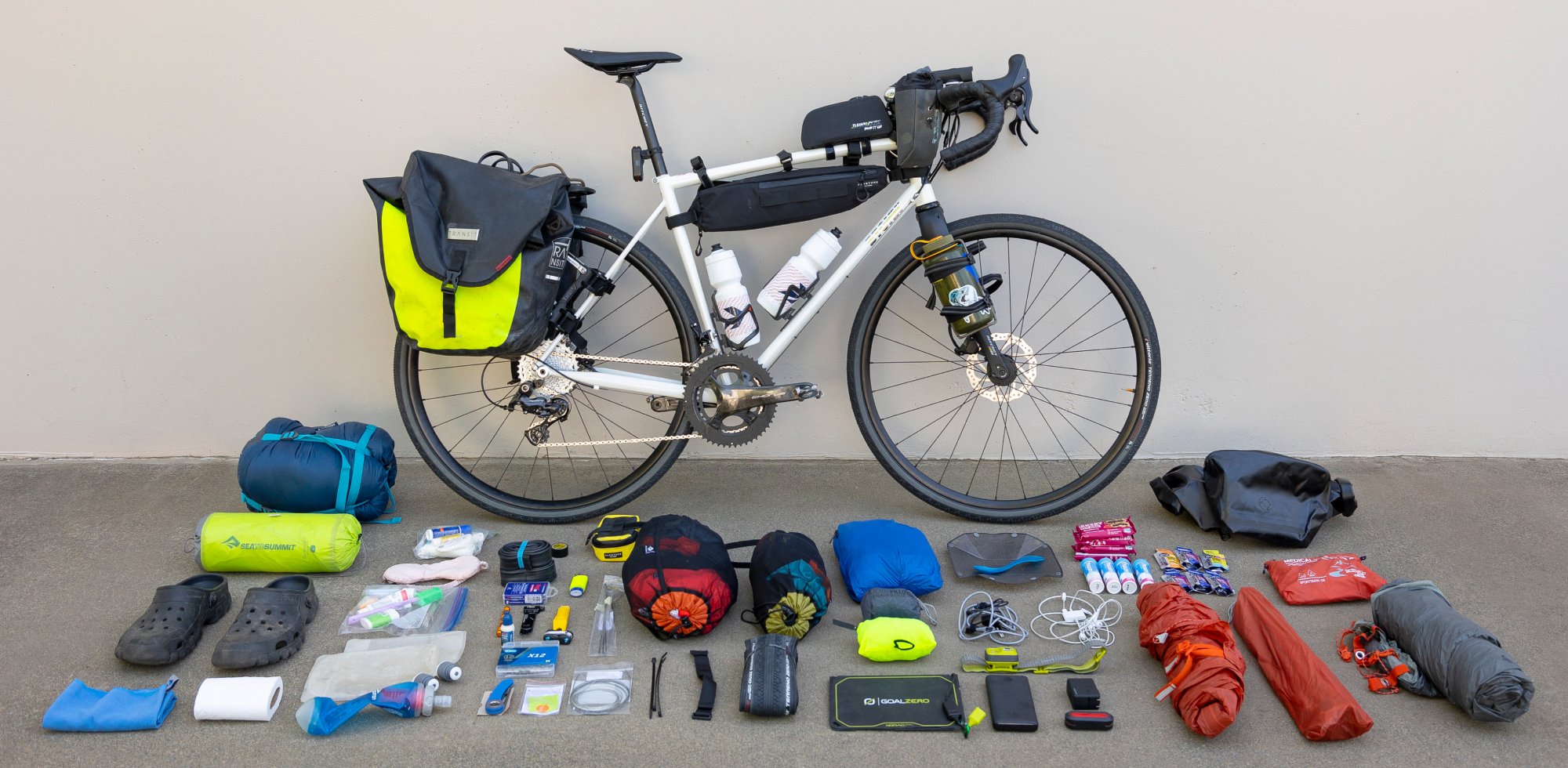 BIKEPACKING GEAR CHECKLIST - Gravel bike with camping gear layed out on the ground