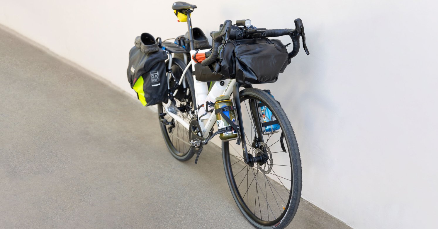 Gravel bike with camping gear packed from the front