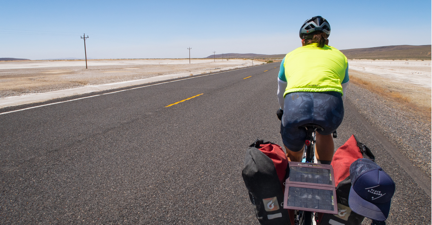 Bikepacker riding on the side of the road