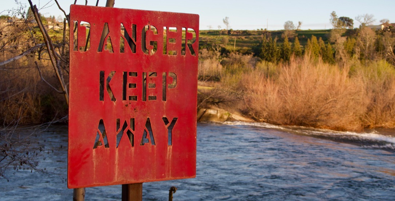 Dange, Keep Away Red sign next to river
