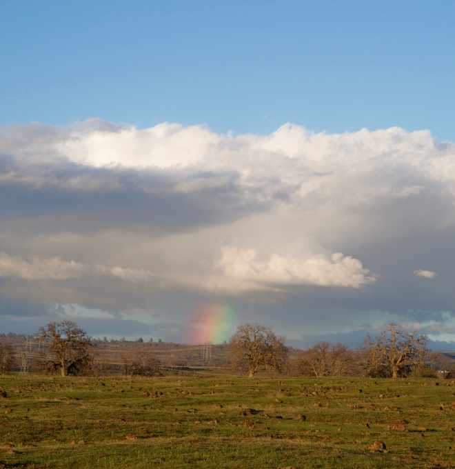 Countryside with clouds and a rainbow