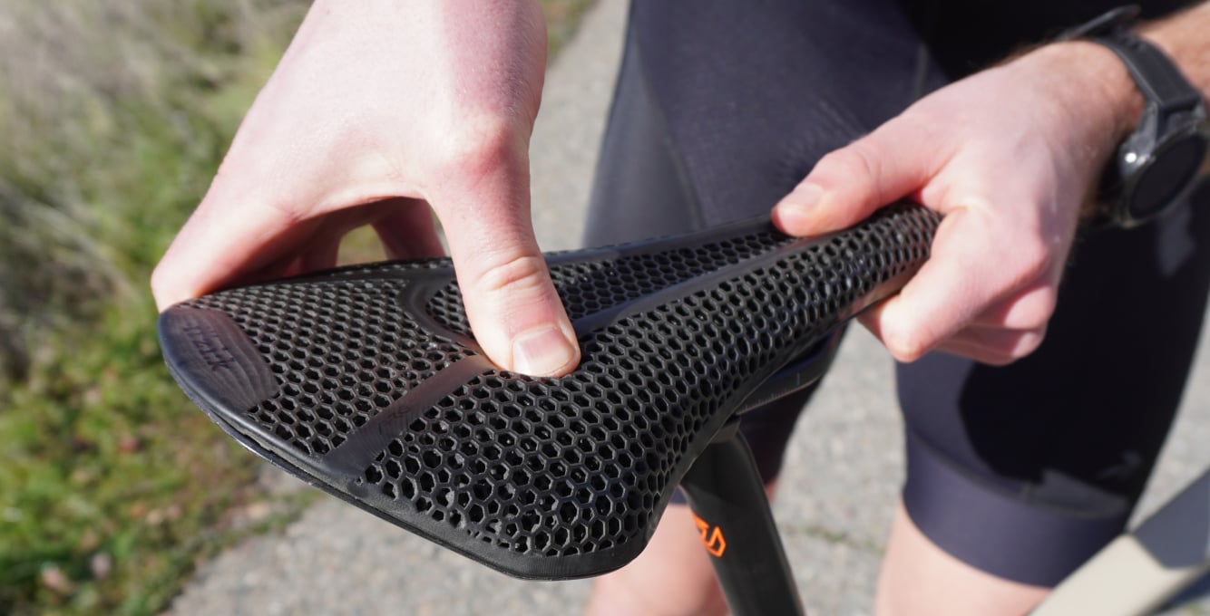 Road cyclist touching Specialized 3D-Printed Mirror Saddle