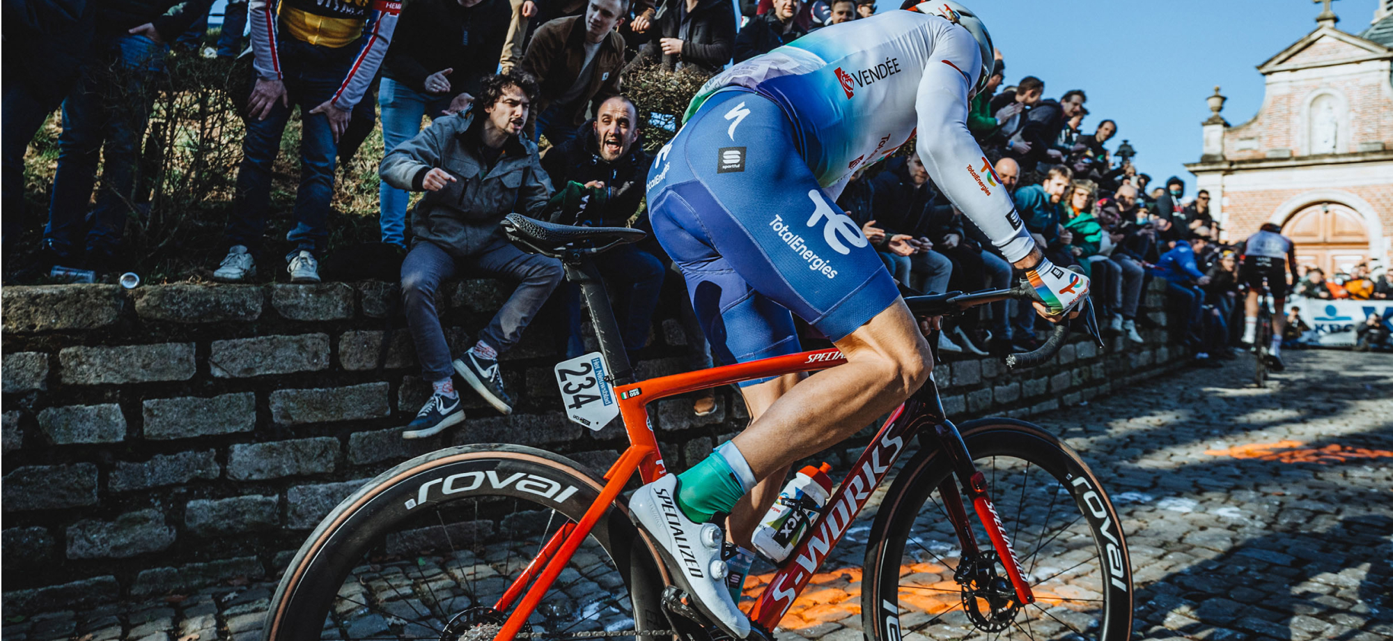 Professional cyclist racing up a cobbled climb in front of screaming fans on S-Works Turbo tires