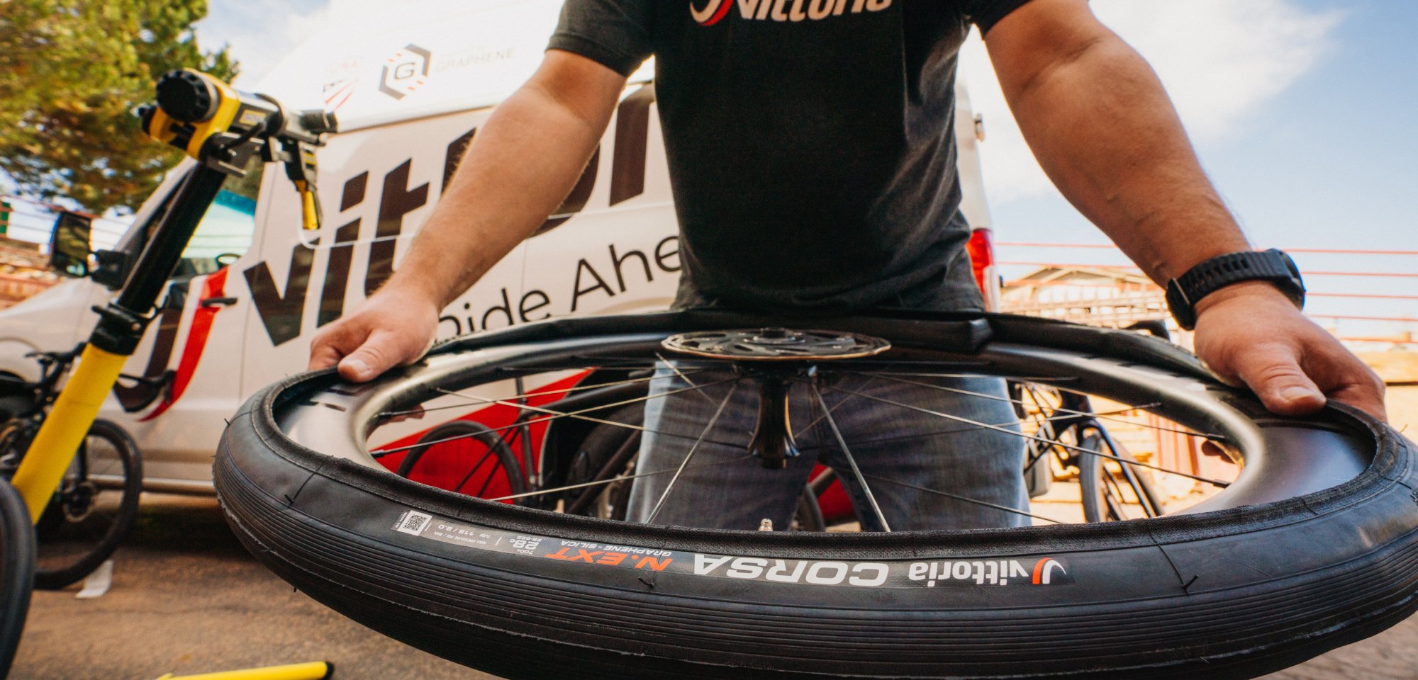 Bike Tires Homepage - Man holding a road tire wheel