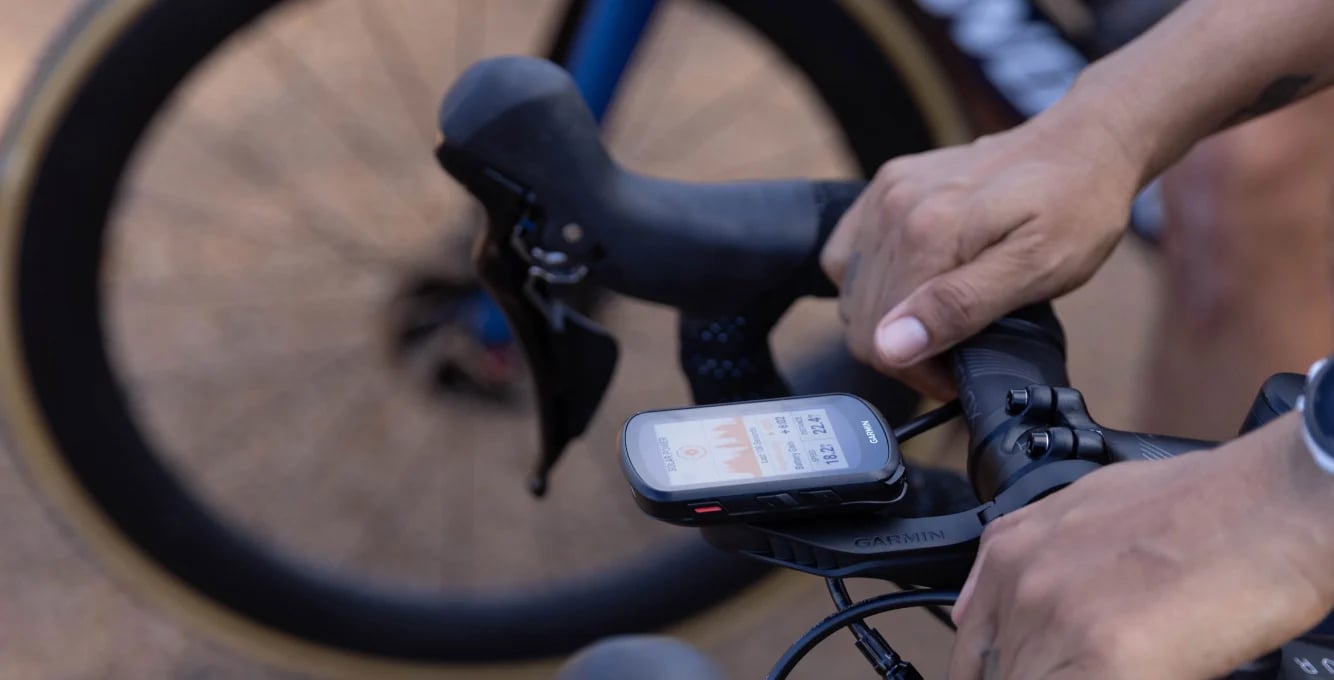 Cyclist looking at garmin computer on bike