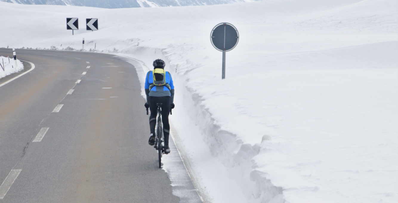 Road cyclist riding in cold weather