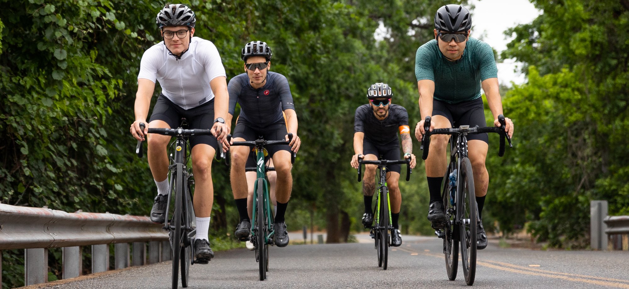 Four men cycling on road bikes