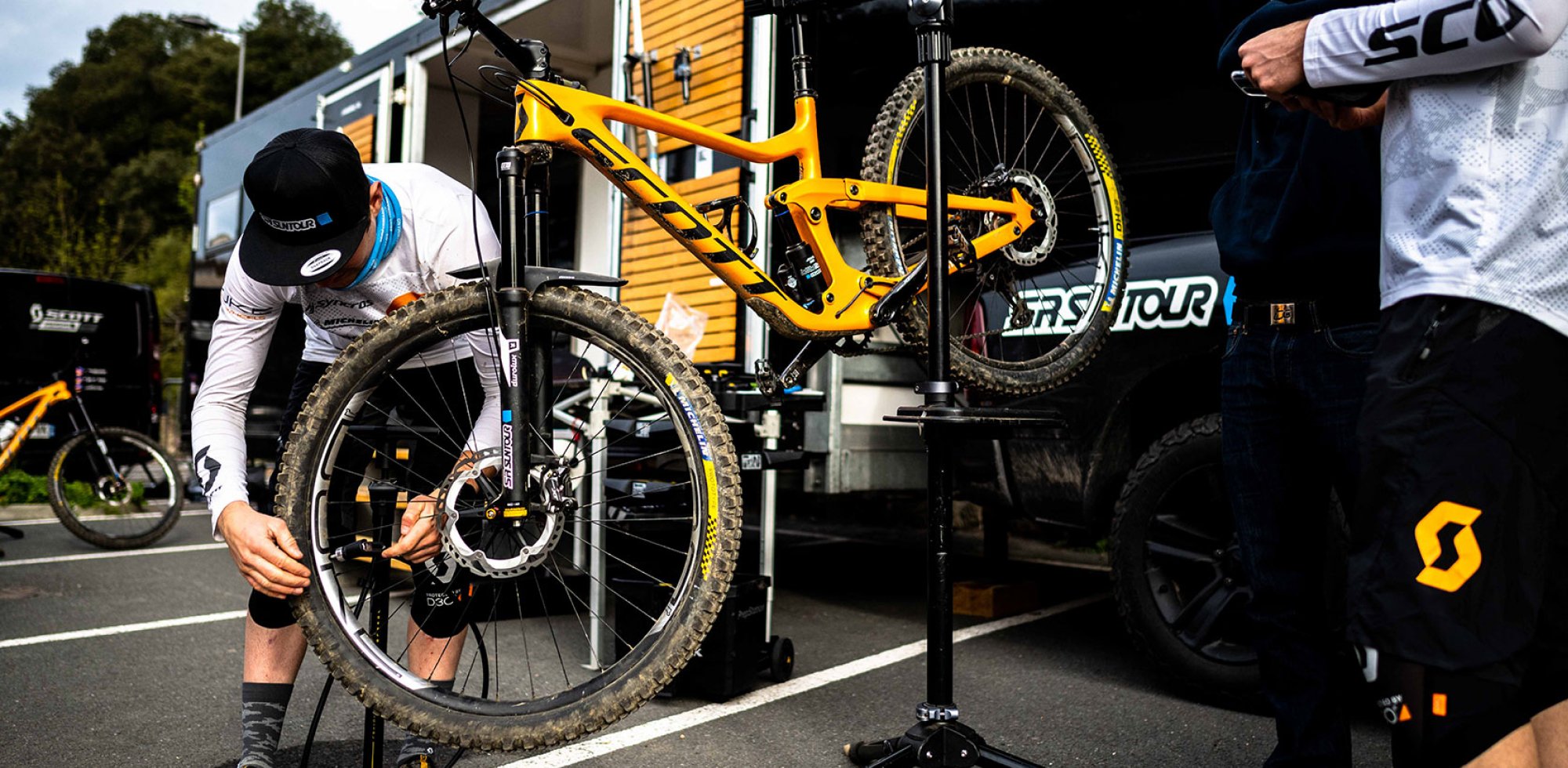 Mountain biker doing repairs with bike on a stand