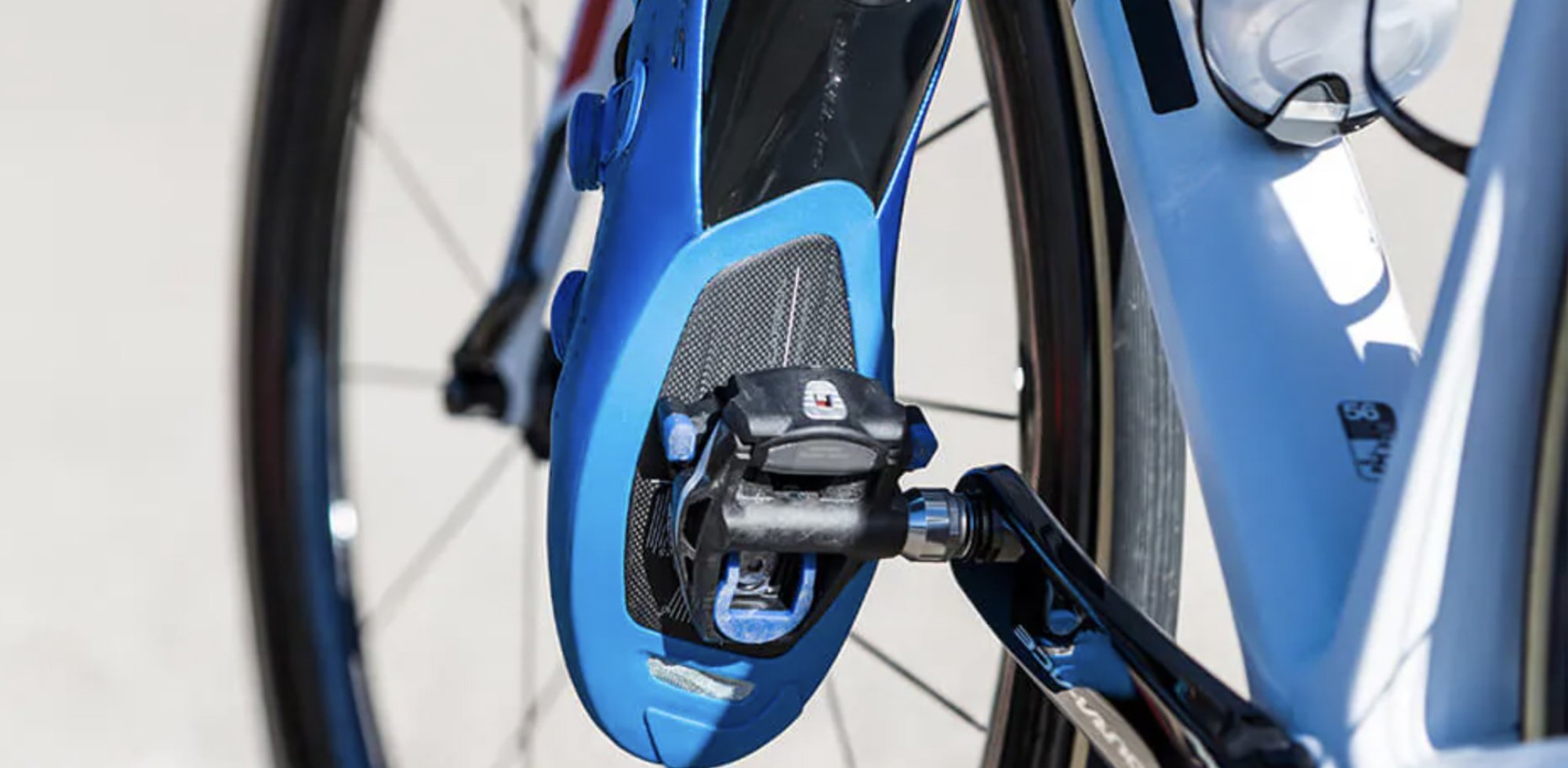 Road bike shoe clipped into traditional road style pedal