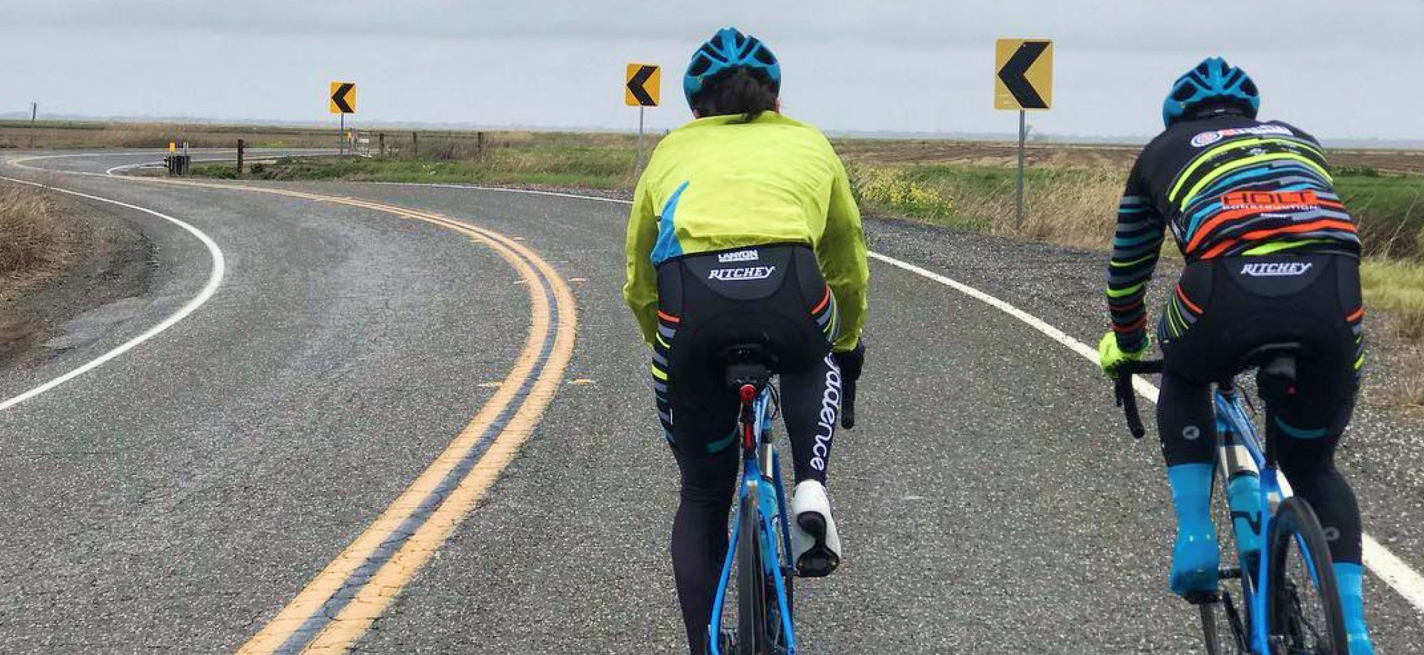 cyclists riding on winter road