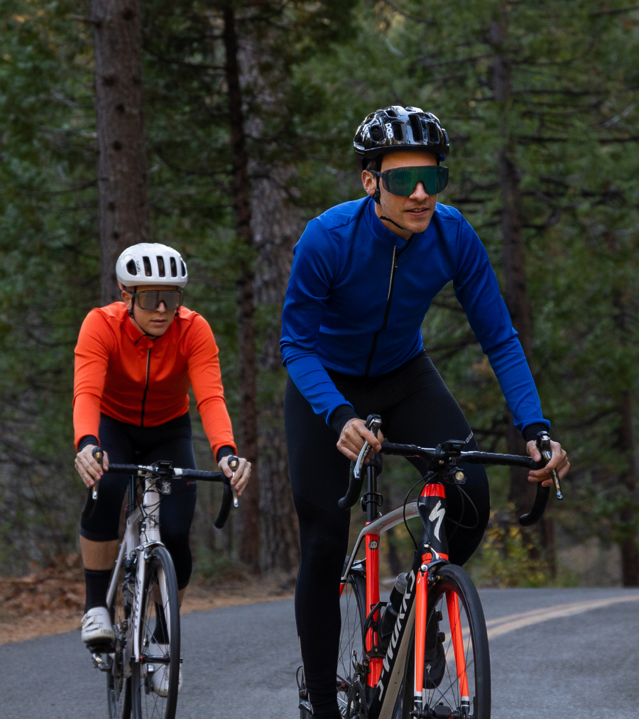 Two cyclists riding in cold weather