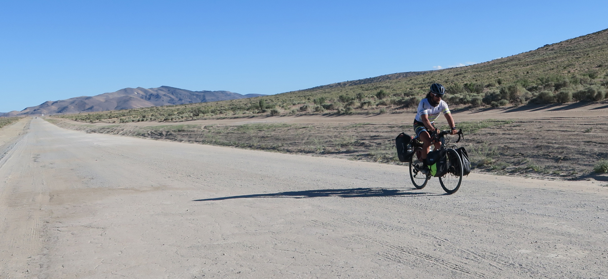 COVERING NEW GROUND - Man biking on gravel road