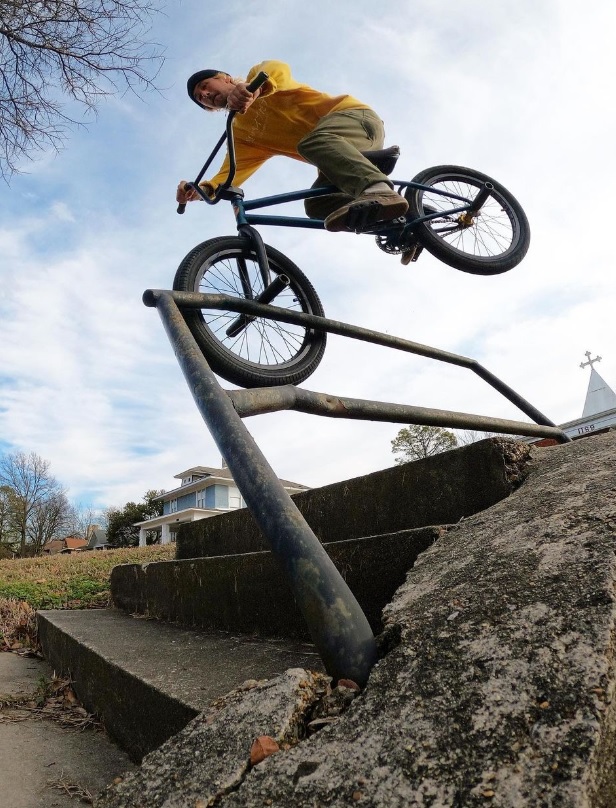 Dan's Comp Flow Team rider Mike Green doing a tooth pick hanger grind down a stair set.