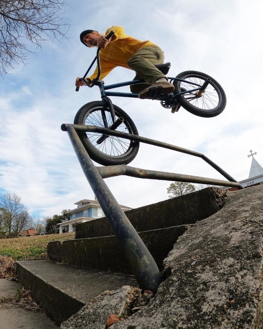 Mike Green doing a toothpick hanger down a rail.