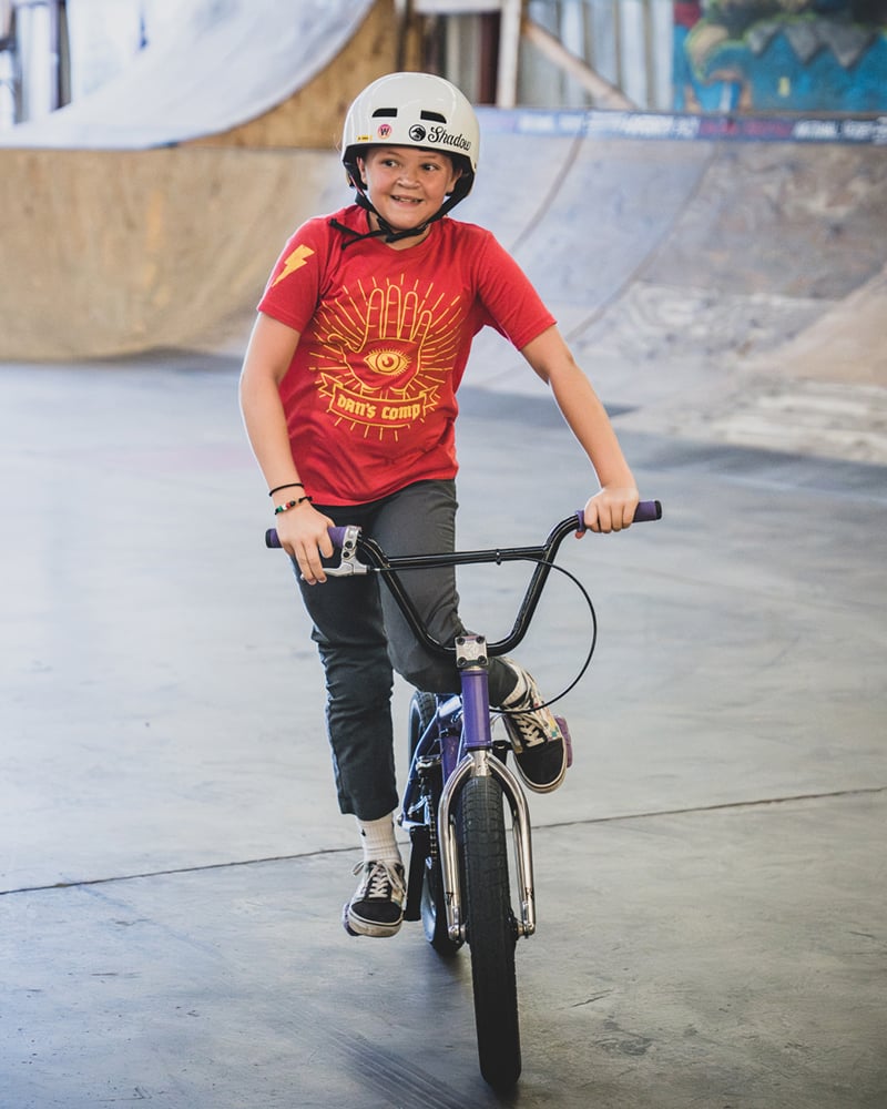 Dans Comp syndicate and young female BMX ripper Lilly Voss rocking a Dan's Comp shirt.